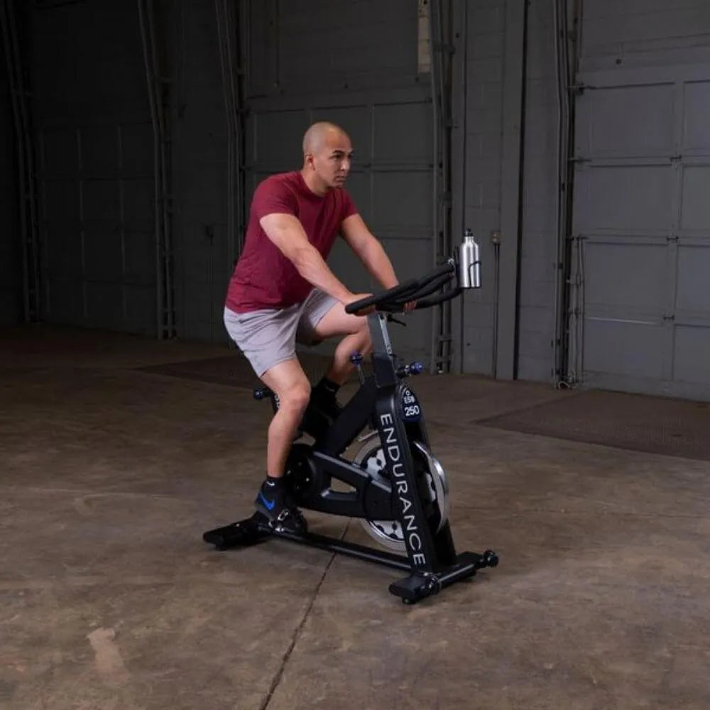 Body-Solid Endurance Spin Bike ESB250 - man seating and hands on the handle
