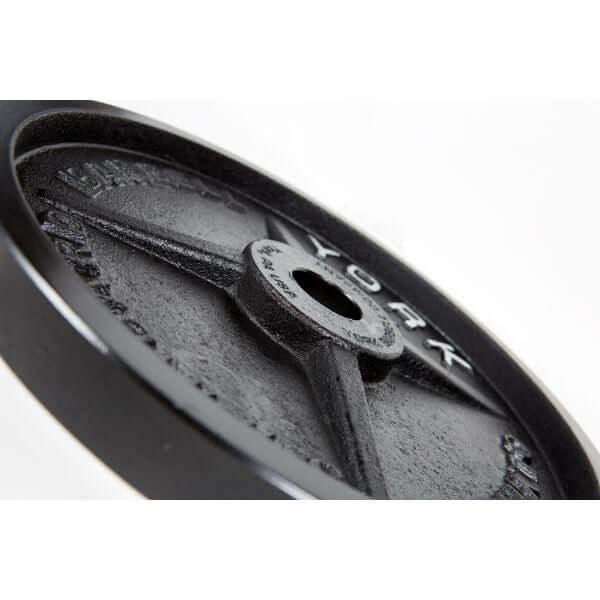 York Barbell Legacy Precision Milled Cast Iron Plate Sets - Close-up of a York brand black weight plate with a central hole