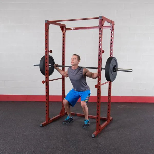 Best Fitness BFPR100 Power Rack - man on squat position with rack and weight to lift
