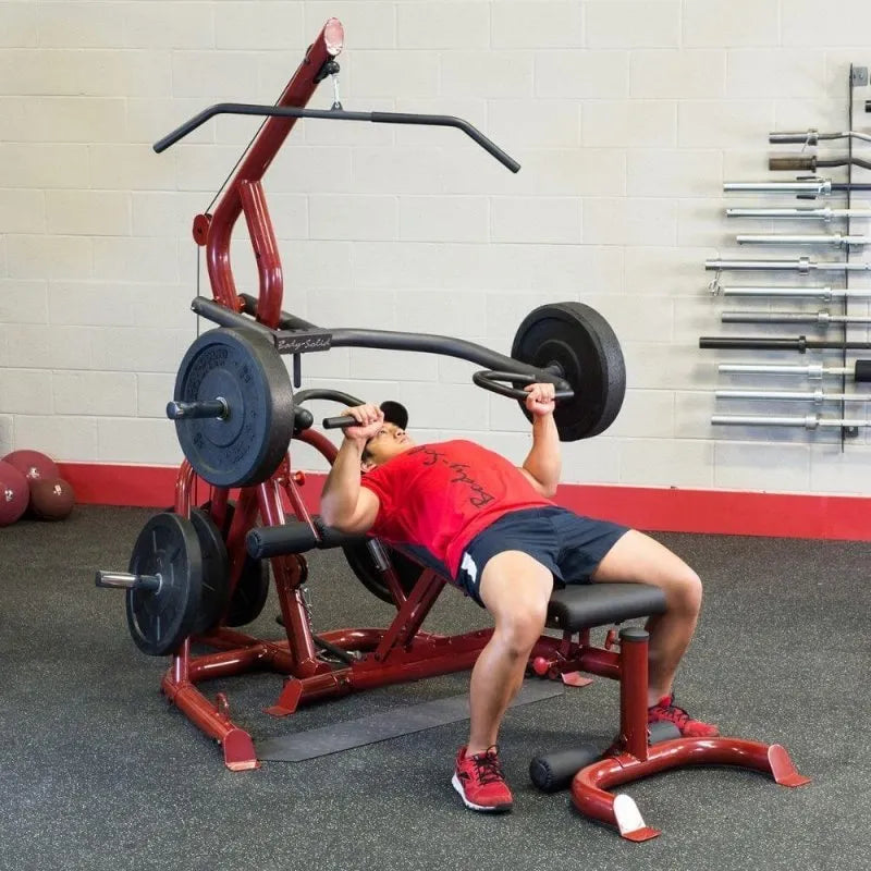 Body-Solid Corner Leverage Gym GLGS100 - Man lying on the bench to lift weights holding press arm