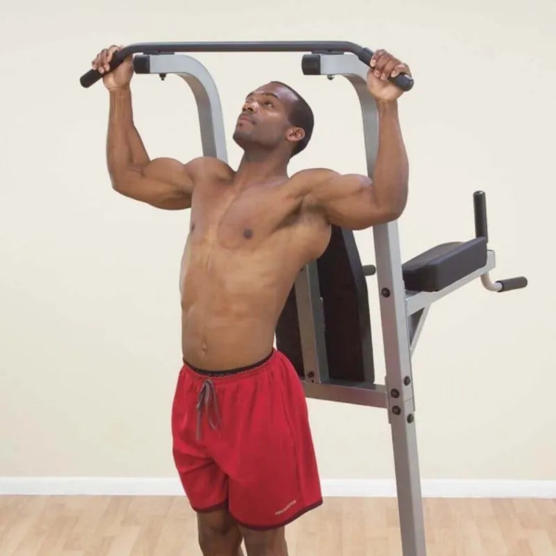 Body-Solid Deluxe Vertical Knee Raise GVKR82 - Man holding the lat bars