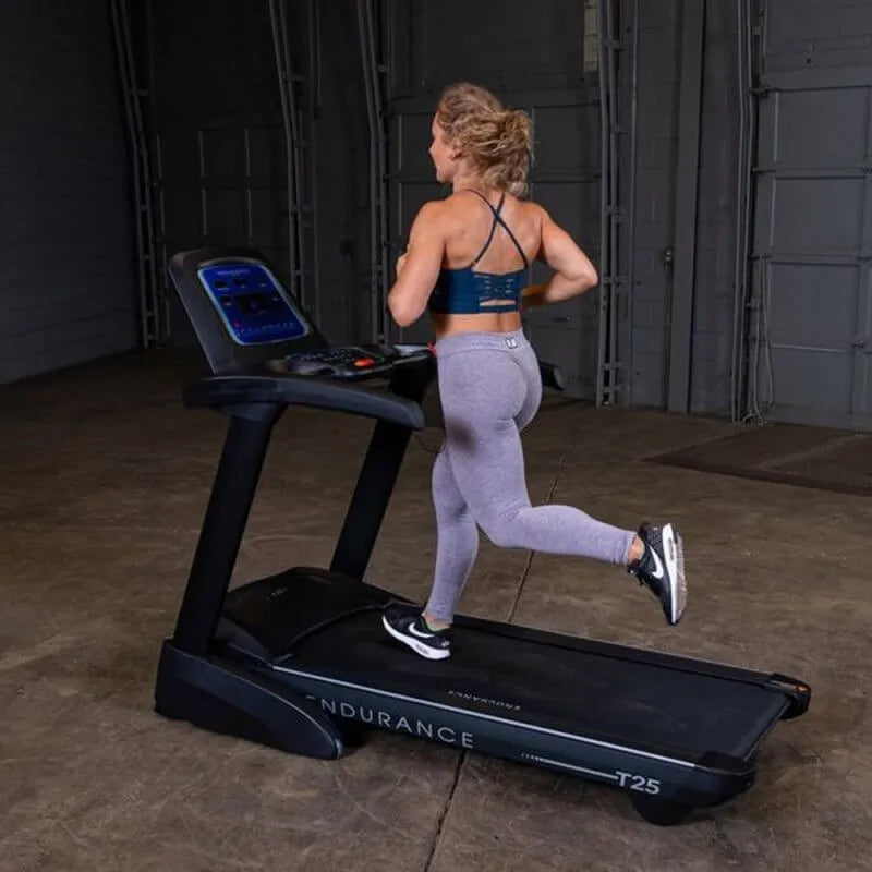 Body-Solid Endurance Folding Treadmill T25 - woman running in the equipment