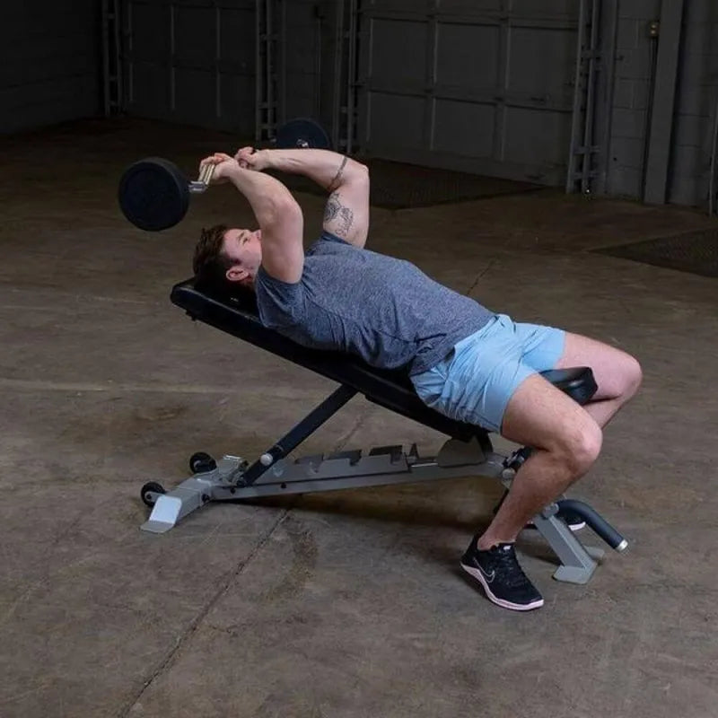 Body-Solid Fixed Curl Bar Sets - Side view photo of man in a bench while working out
