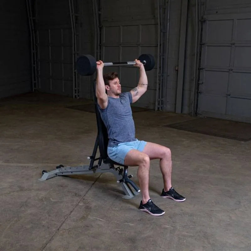 Body-Solid Fixed Straight Bars - Man sitting on bench and lifting barbell