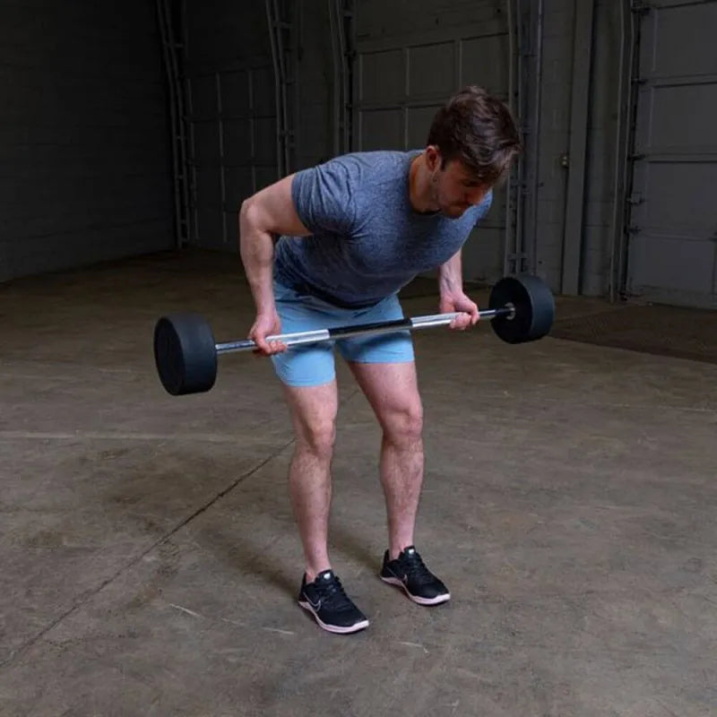 Body-Solid Fixed Straight Bars - Man curl down position while holding a barbell
