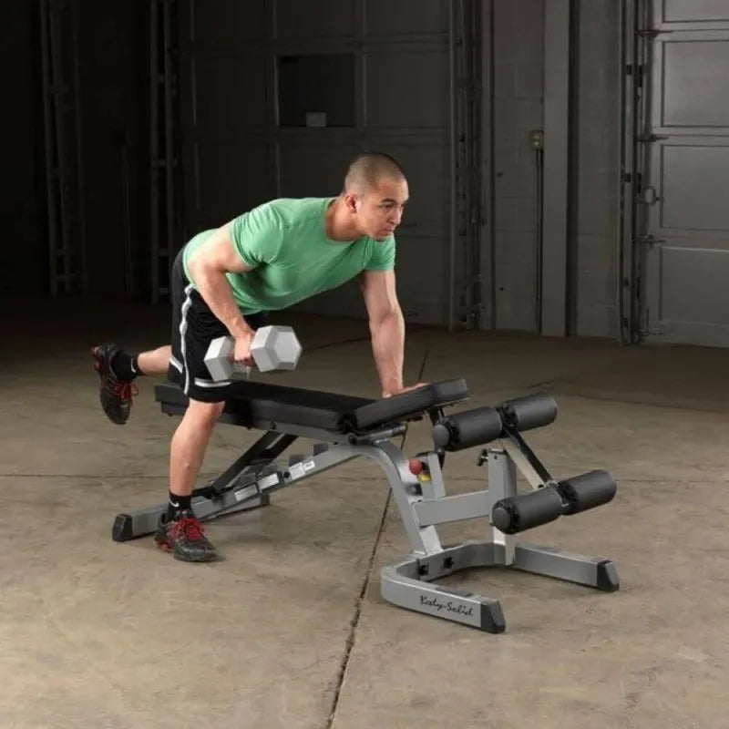 Body-Solid Flat Incline Decline Bench GFID71 - Man in green shirt holding silver dumbbell