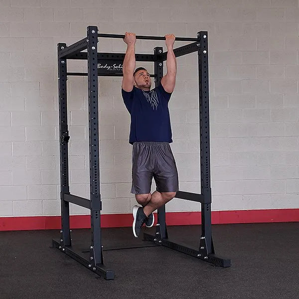 Body Solid Pro Club Line Power Rack Double Rack/Extension w Monkey Bar - man doing pull ups
