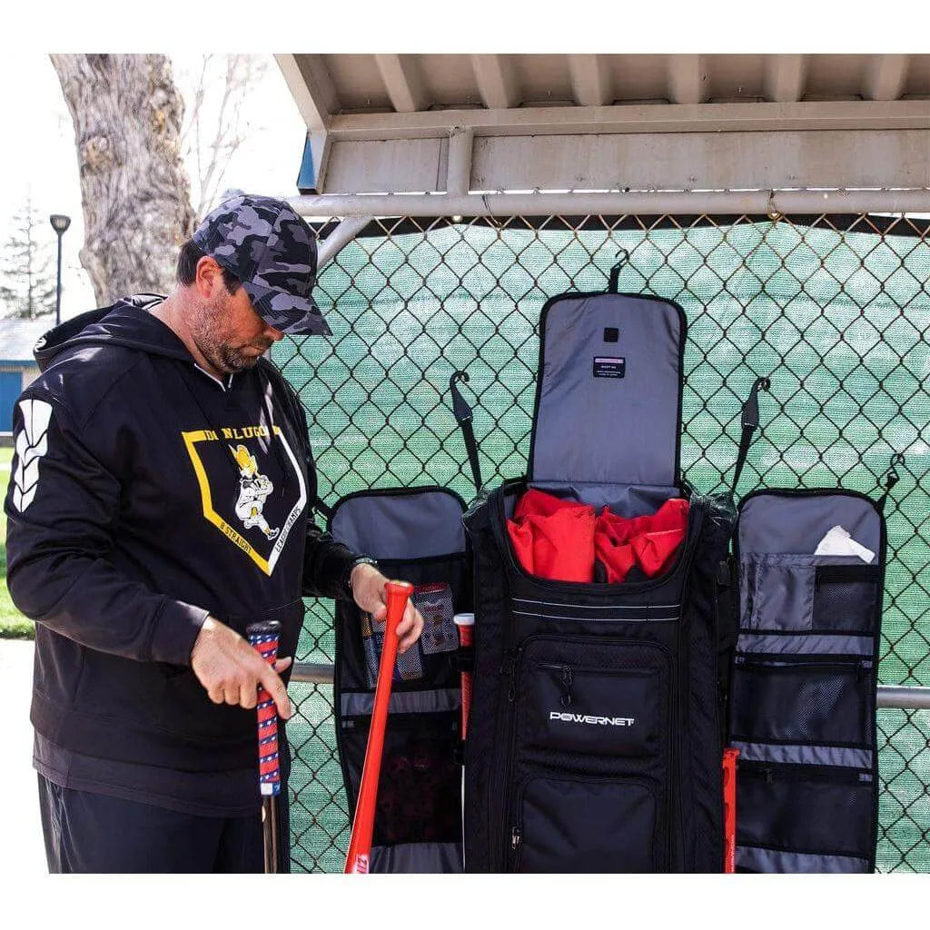 A person holding baseball bats beside Powernet All Gear Transporter Rolling Baseball Equipment Bag for Coaches B007