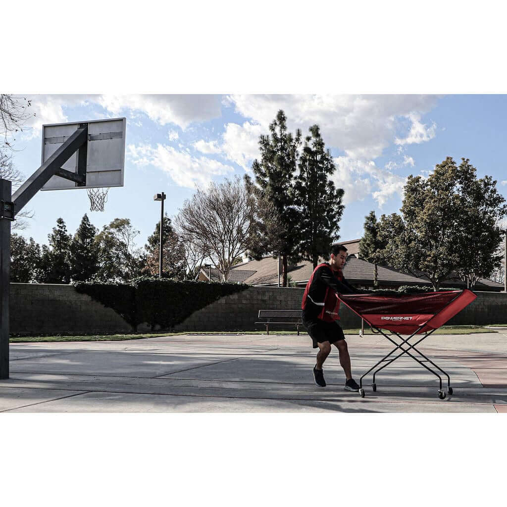 A boy in a court with Powernet Volleyball Wheeled Cart 1188