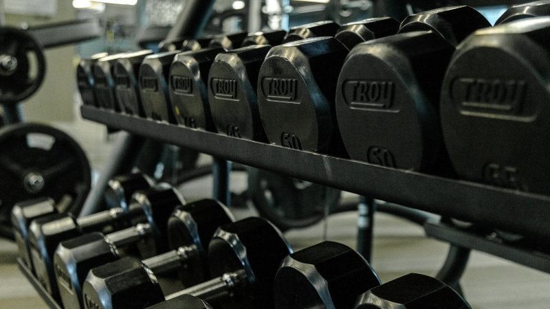 12 Sided Rubber Dumbbell - bunch of them on a rack