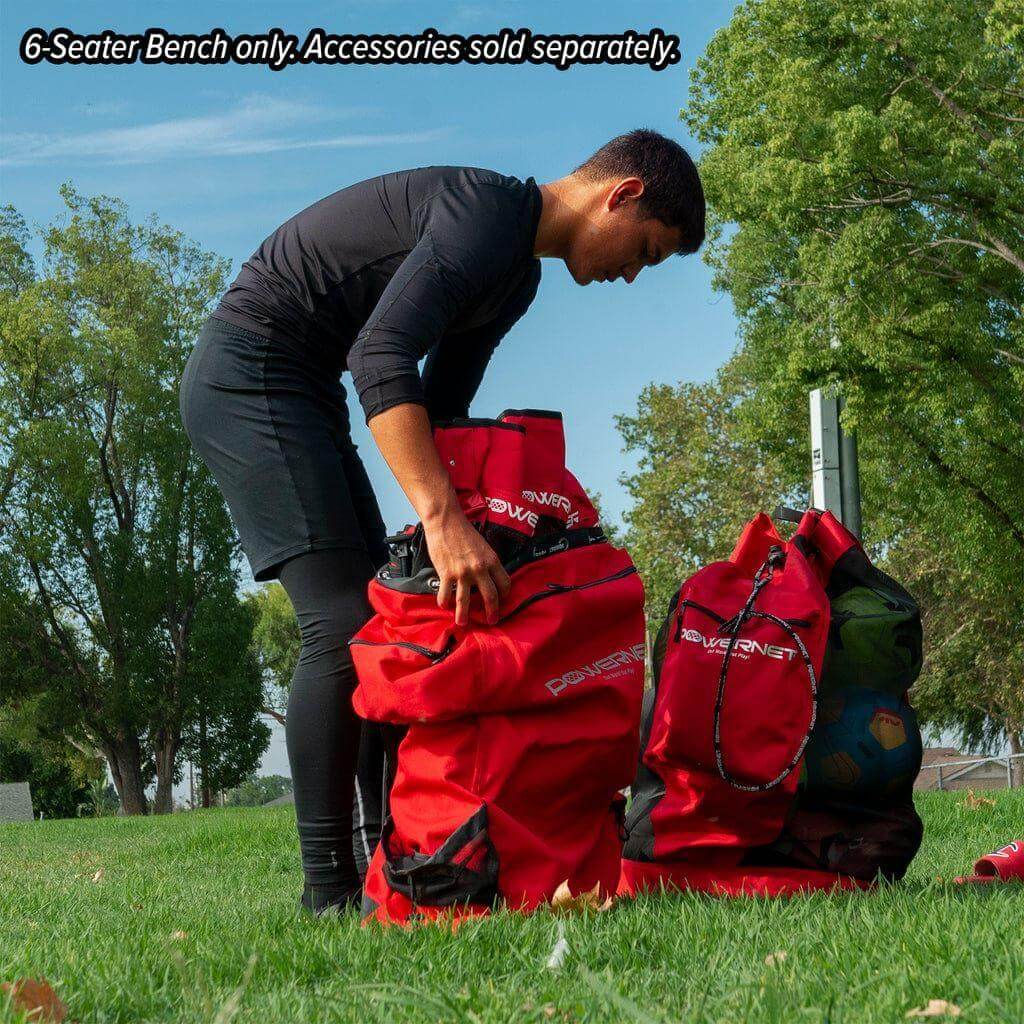 A boy placing Powernet 6-Seater Team Bench 1209 inside a bag
