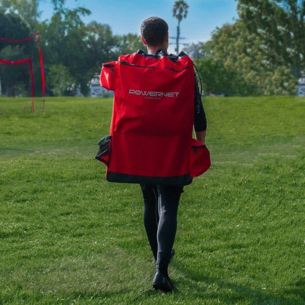 A boy carrying a Powernet 6-Seater Team Bench 1209 on his back walking in a field