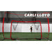 Olympic gold medalist Carli Lloyd playing soccer indoors using Powernet 16x10 Ft Soccer Goal Combo Barrier 1214