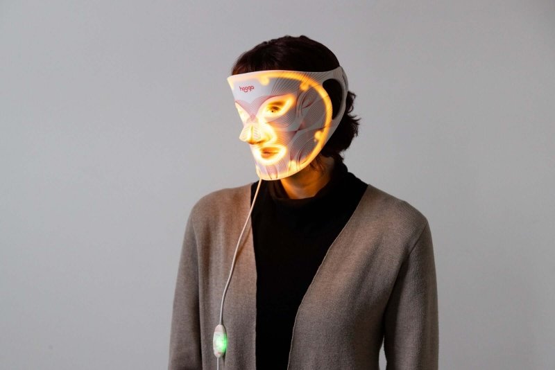 7 Color LED Light Mask - person wearing the mask with yellow lights on