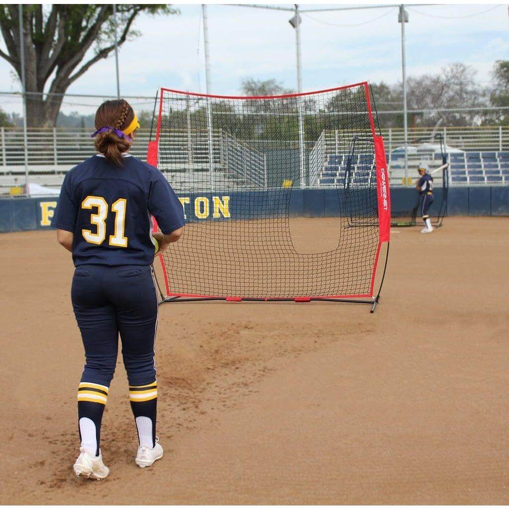 Two girls playing outdoors using Powernet 7x7 FT Pitch-Thru Protection Screen for Softball 49 SQFT Barrier 1090
