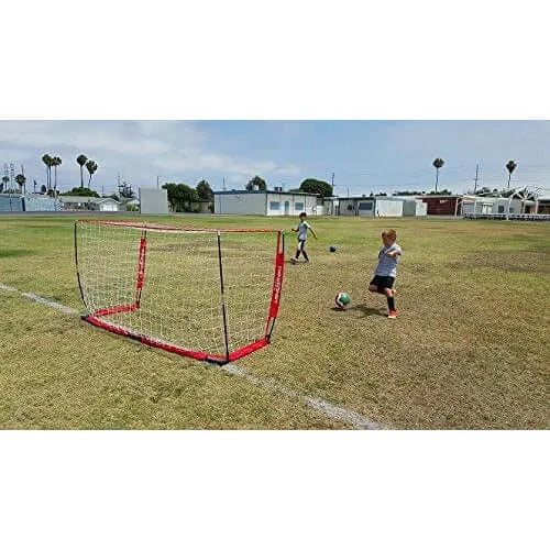 Two children in a field using Powernet Soccer Goal 8x4 Portable Bow Style Net S002 while playing soccer