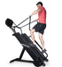 Ropeflex RX4400 APEX Tread Climbing Rope Trainer - A man is pulling a rope while climbing a gym machine