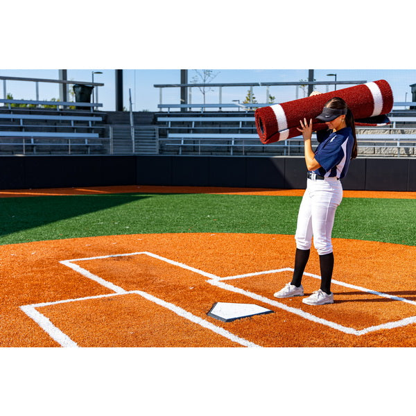 Portolite Half Batter's Mat - woman carrying the rolled up mat 