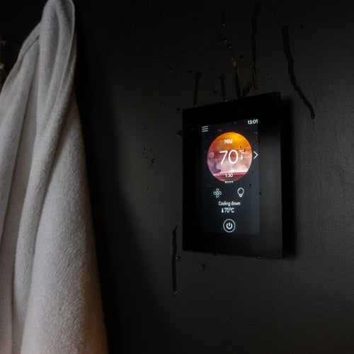 Harvia Fenix Sauna WiFi Remote Control Panel - On wooden wall with white towel beside