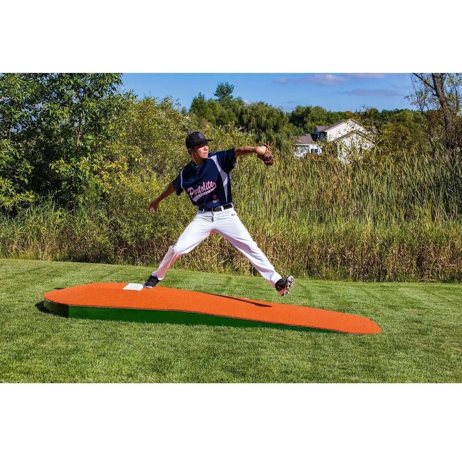 Portolite 10" One-Piece Portable Baseball Practice Pitching Mound 1175 - outdoors with grass and house