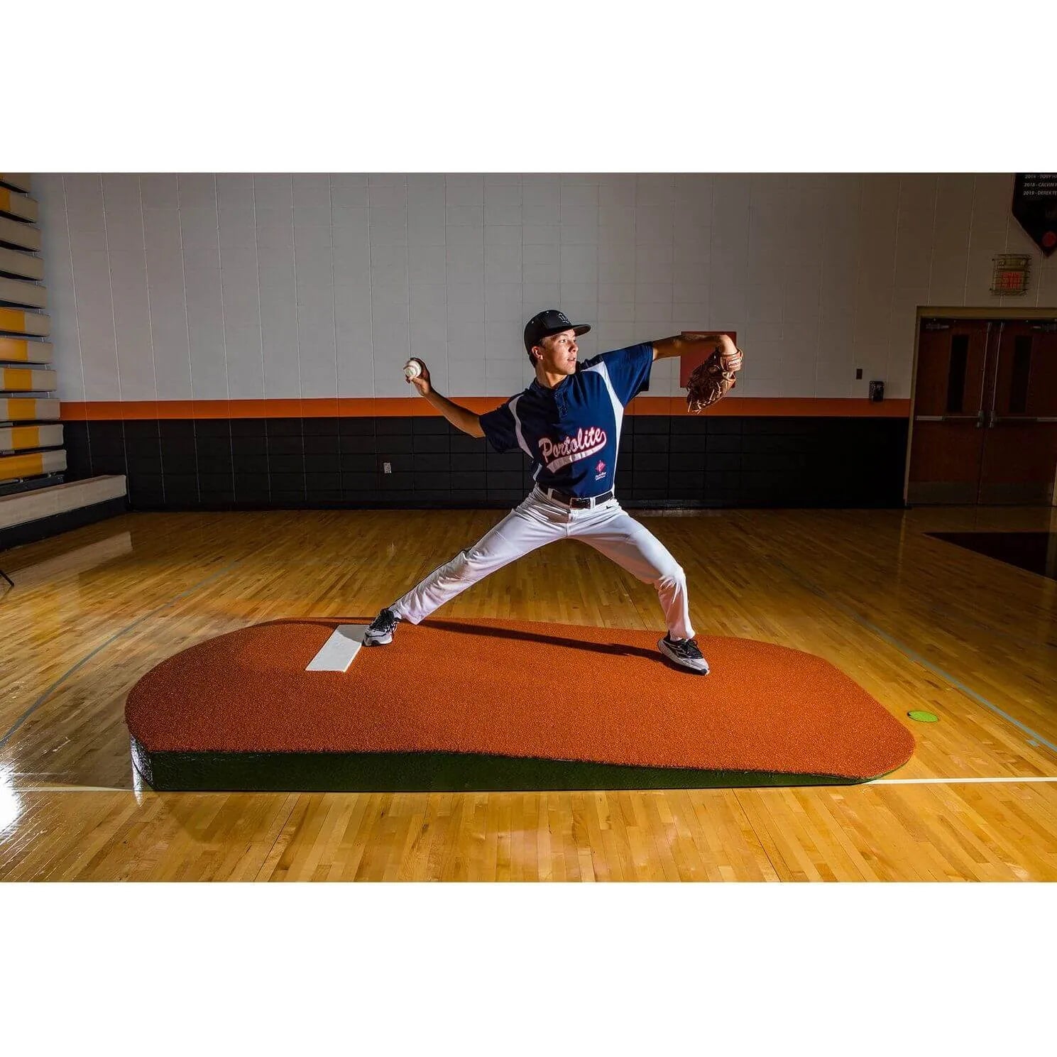 Portolite 10" One-Piece Portable Baseball Practice Pitching Mound 1175 - on a wooden floor and walls 