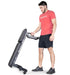 Ropeflex RXB2 Flat Bench - A man is standing straight while holding up a wheeled flat bench