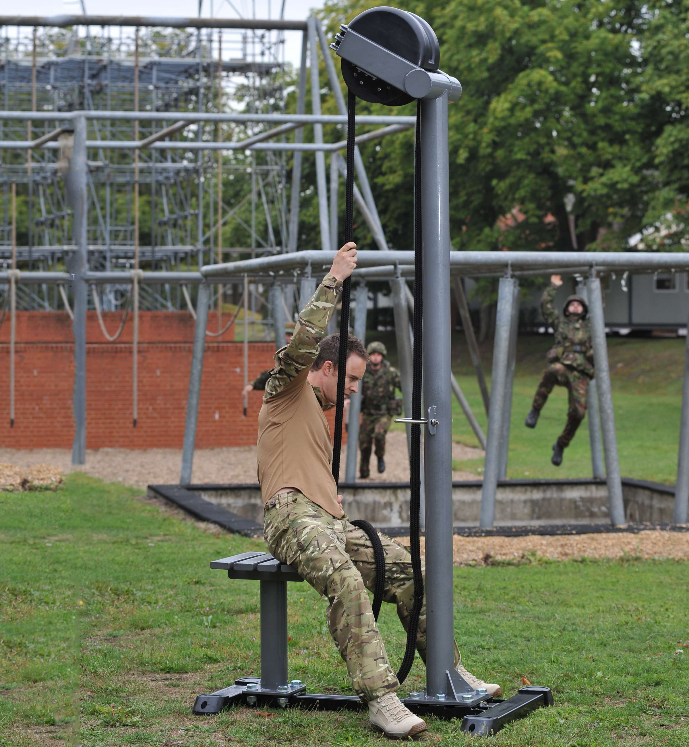 Ropeflex RX5500 Oryx 2 Outdoor Vertical Rope Trainer - A military personnel is using an outdoor fitness machine to exercise