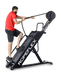 Ropeflex RX4400 APEX Tread Climbing Rope Trainer - A man standing on a fitness machine while pulling a rope