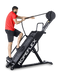 Ropeflex RX4400 APEX Tread Climbing Rope Trainer - A man standing on a fitness machine while pulling a rope