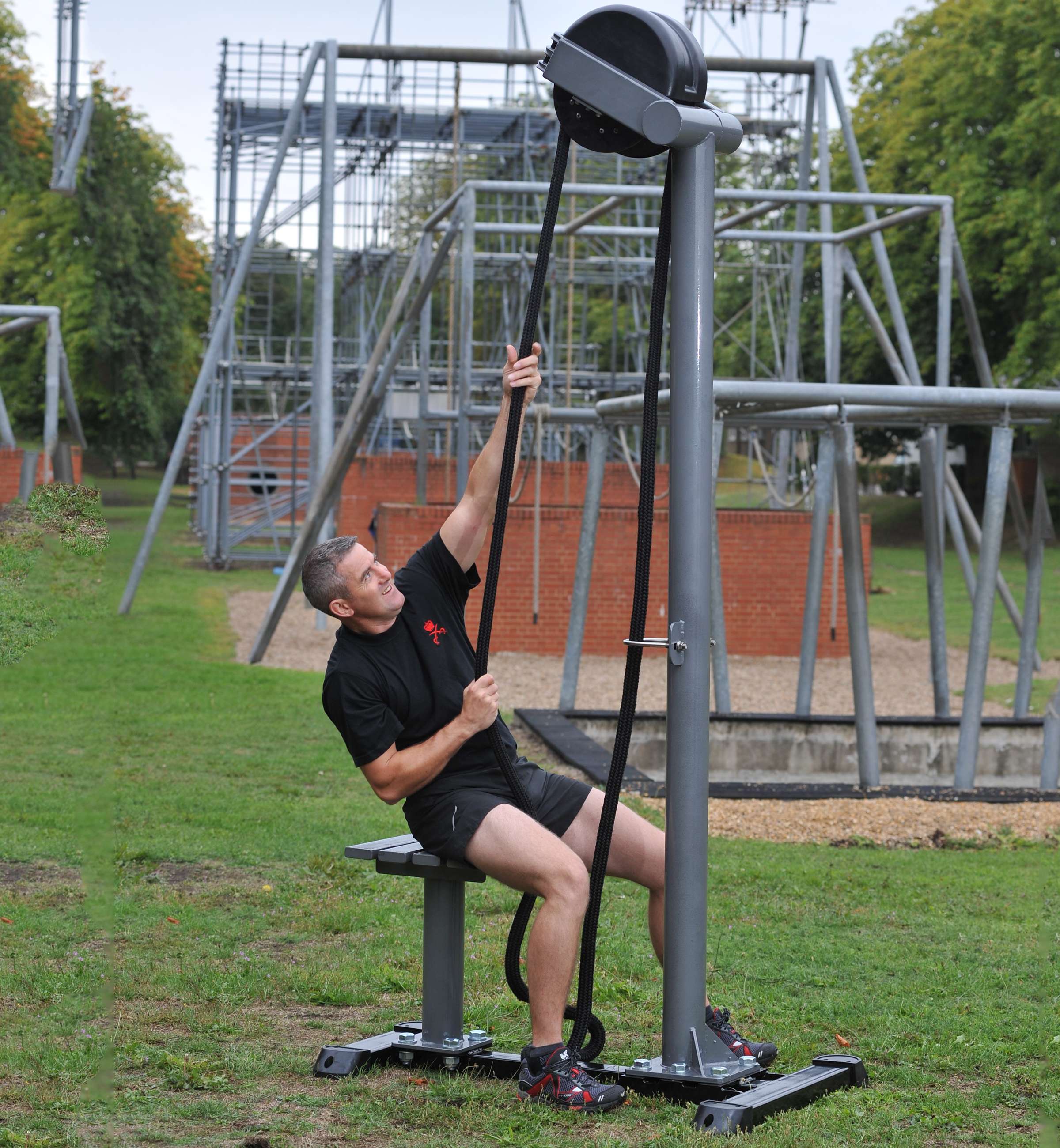 Ropeflex RX5500 Oryx 2 Outdoor Vertical Rope Trainer - A man pulling a rope on an outdoor exercise machine