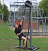 Ropeflex RX5500 Oryx 2 Outdoor Vertical Rope Trainer - A man pulling a rope on an outdoor exercise machine