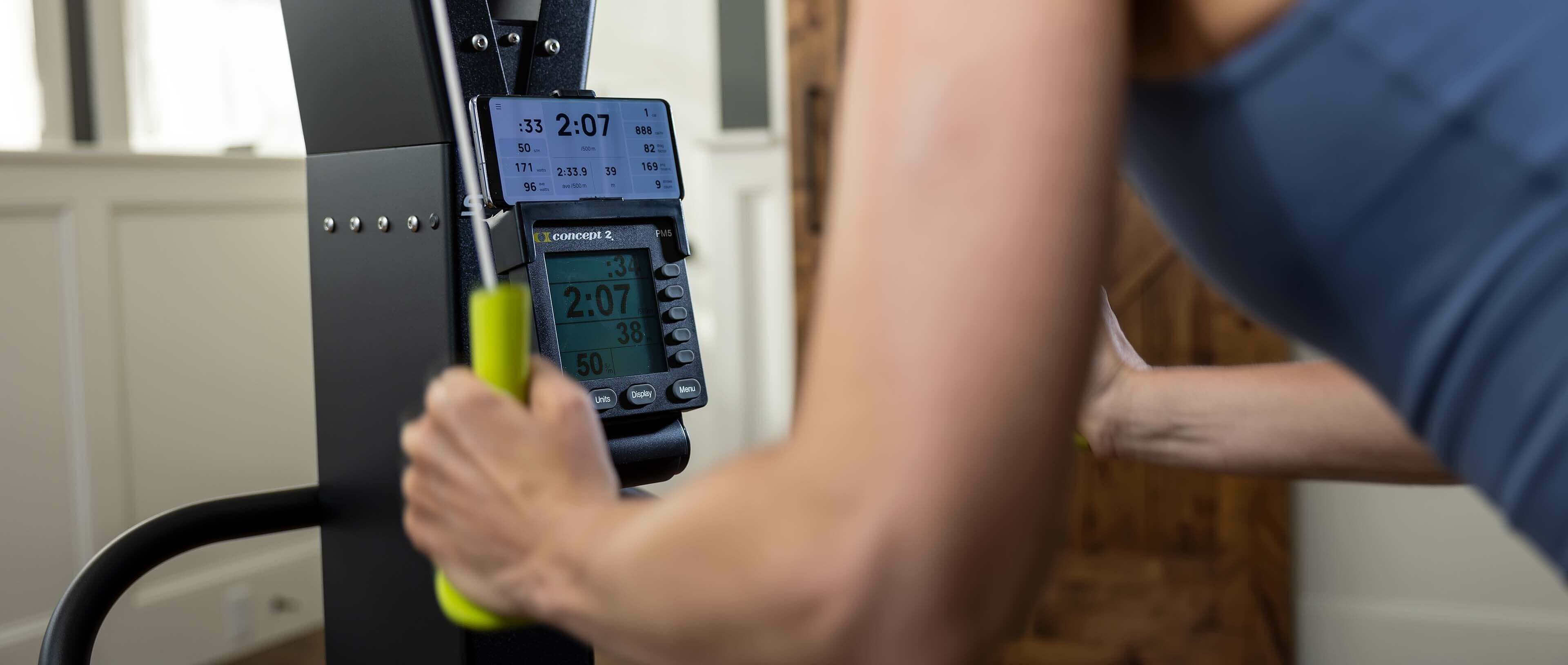 User performing a workout on the Skierg Concept 2 with digital display and ergonomic handles.