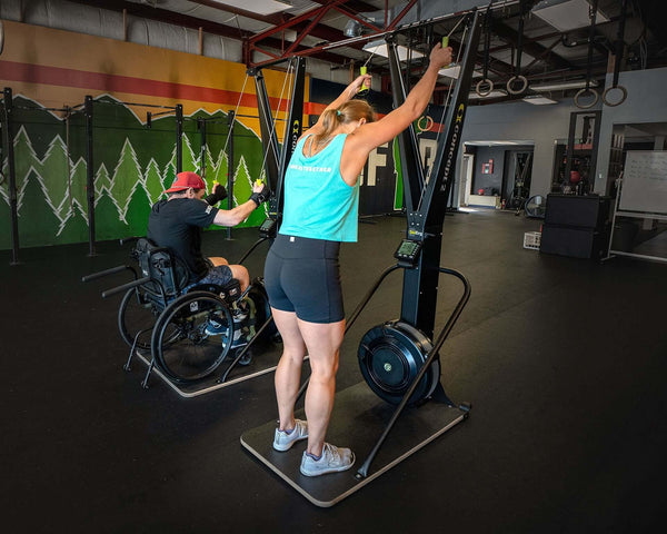 Skierg Concept 2 in use by athletes, showcasing adaptive training in a gym environment.