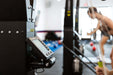 Skierg Concept 2 monitor and equipment in a fitness studio with fitness enthusiast in the background.