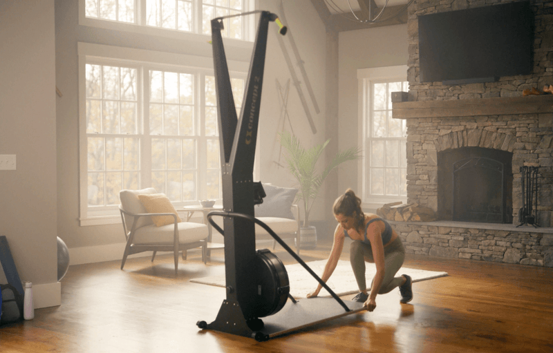 Skierg Concept 2 being used indoors by a person for effective workout in a stylish home setting.