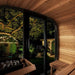 SaunaLife Model CL5G Outdoor Home Sauna - Cozy wooden interior of a sauna with a view of a garden at night