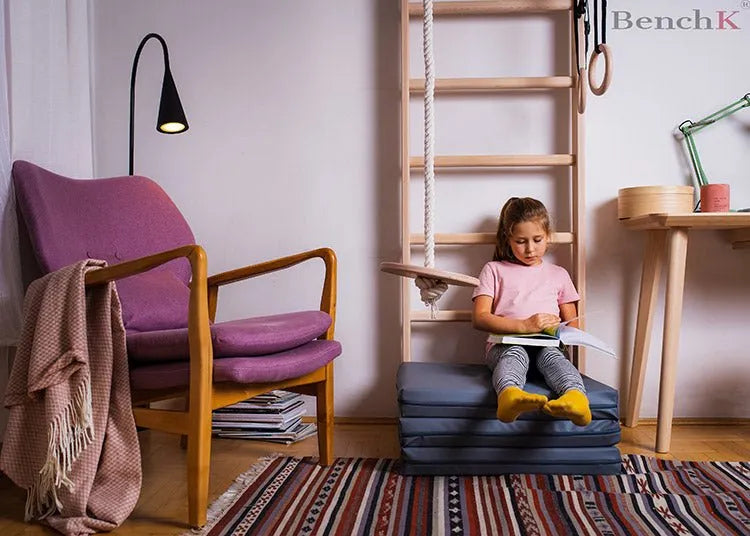 BenchK Gymnastics Mat - Front photo of a girl sitting on top of the gray mat