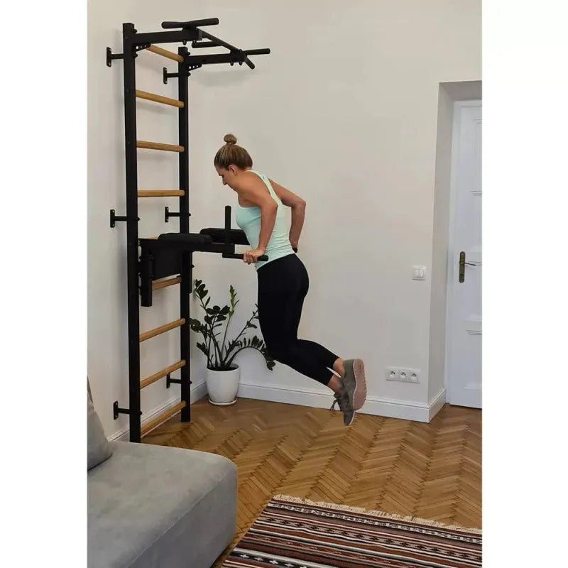 BenchK Stall Bar With Pull-up Bar and Dip Station 722B - In black color side view photo of a woman working out in dip bar