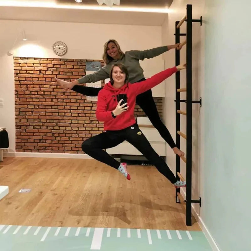 BenchK Wall Bars 700B/700W -  two woman with hands and foot on wall bar