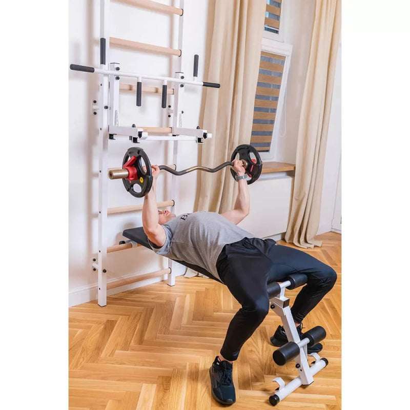 BenchK Wall Bars 733B - Man laying down in bench while holding barbell