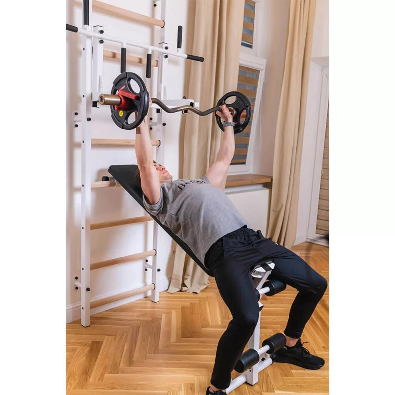 BenchK Wall Bars 733B - Man in inclined position while holding the barbell 