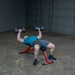 Best Fitness BFFID25 Adjustable Bench - Man laying down on bench doing arm workout