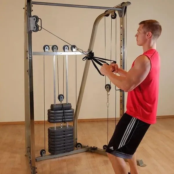 Best Fitness BFFT10R Functional Trainer - man on full strength using two hands on pulleys