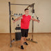 Best Fitness BFFT10R Functional Trainer -man while arms on  pulleys