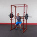 Best Fitness BFPR100 Power Rack - man on squat position with rack and weight to lift