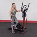 Best Fitness Cross Trainer Elliptical - woman smiling standing and stepping one foot on the actual product