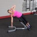 Body-Solid 45° Back Hyperextension GHYP345 - Woman in pink tank top working out using GHYP345