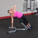 Body-Solid 45° Back Hyperextension GHYP345 - Woman in pink tank top working out using GHYP345