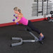 Body-Solid 45° Back Hyperextension GHYP345 - Woman in pink top holding 2 purple dumbbells