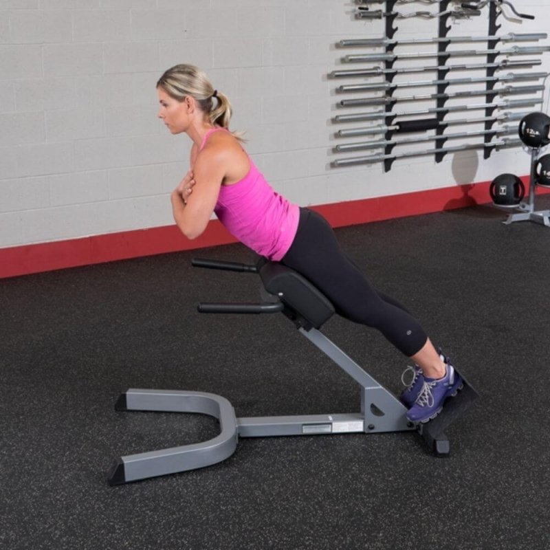 Body-Solid 45° Back Hyperextension GHYP345 - Woman in pink tank top doing upper body exercise